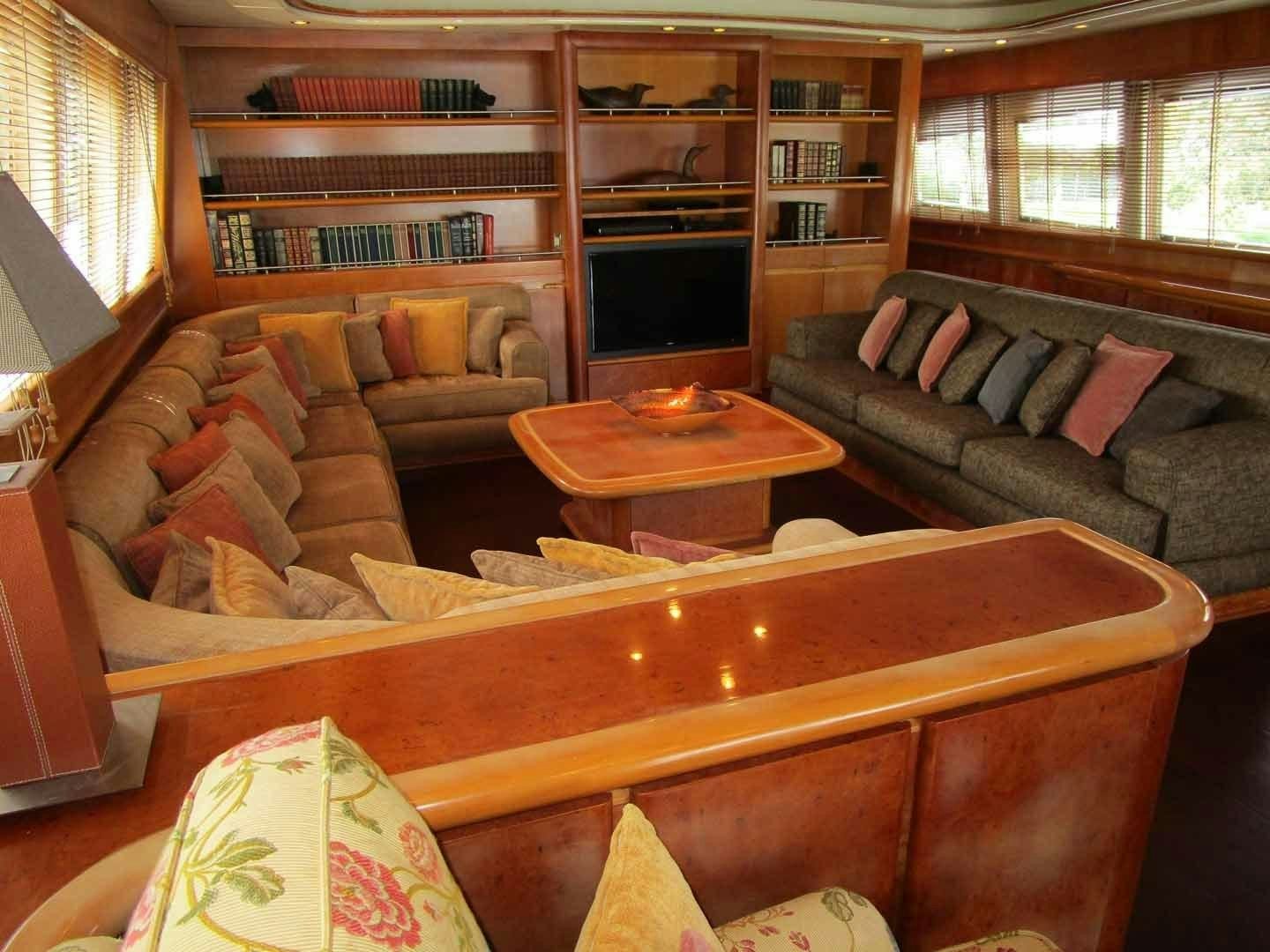 a living room with a bookcase aboard DEAR HENRI Yacht for Sale