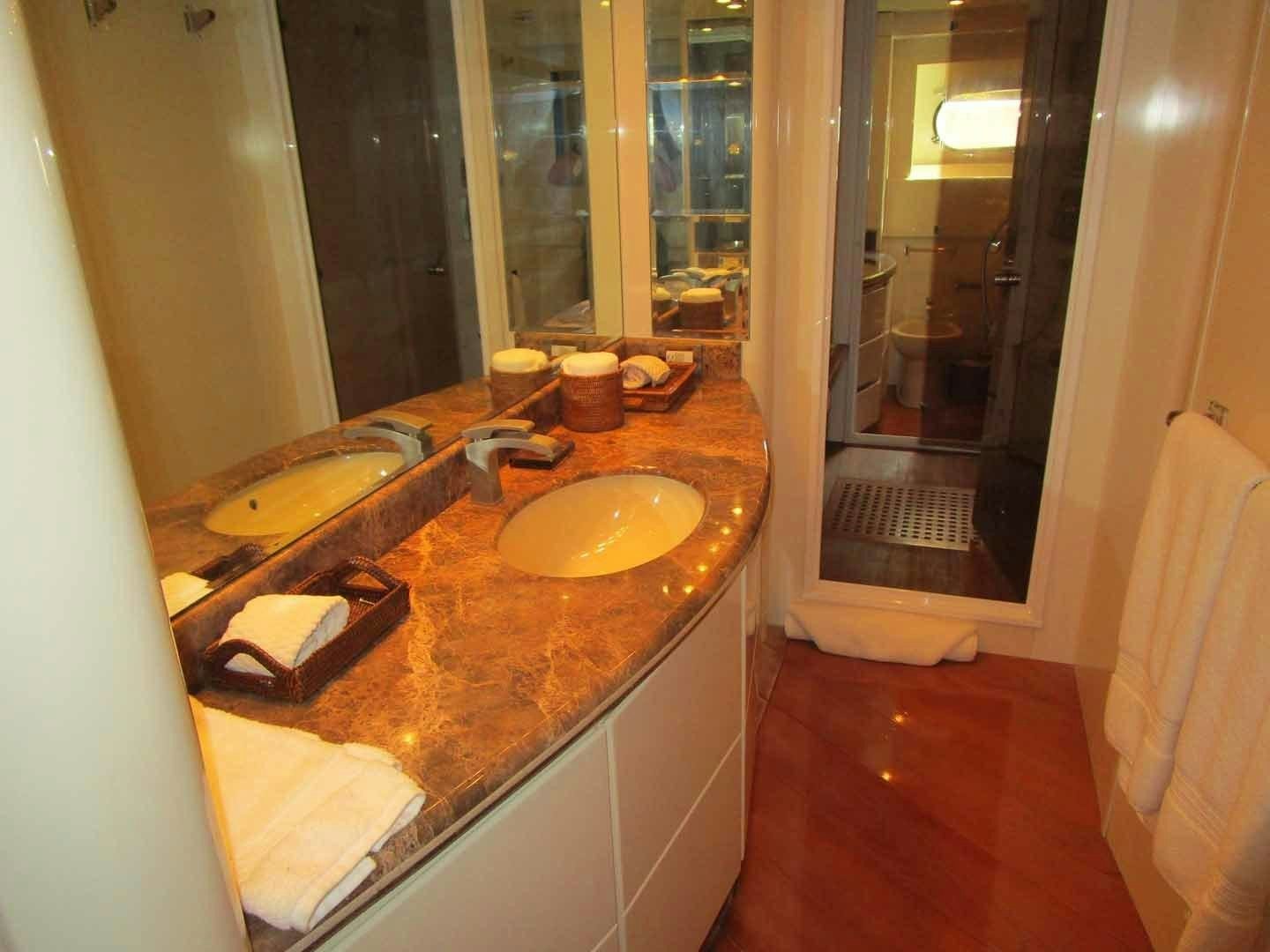 a bathroom with a countertop sink and mirror aboard DEAR HENRI Yacht for Sale