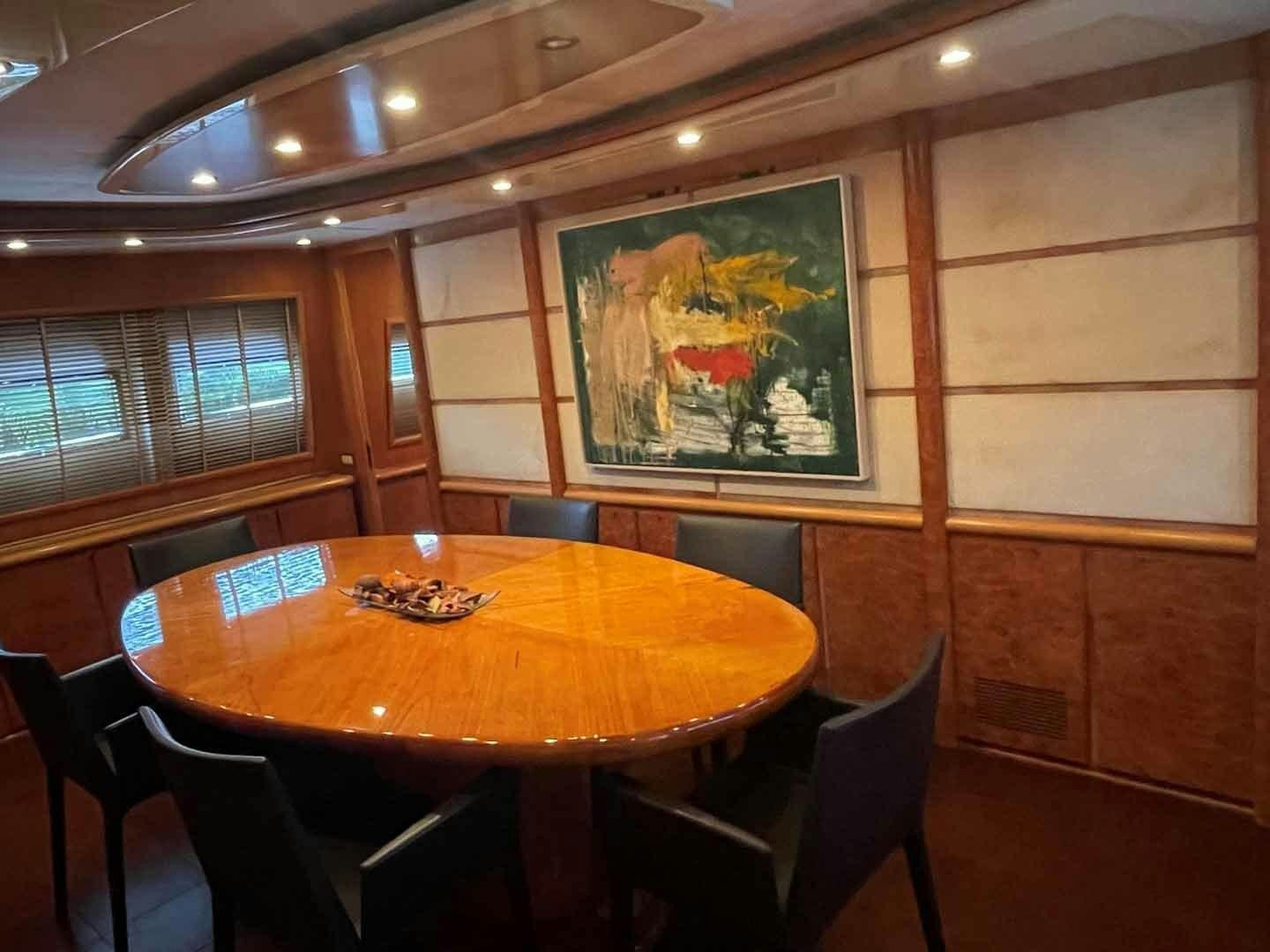 a table with chairs around it aboard DEAR HENRI Yacht for Sale