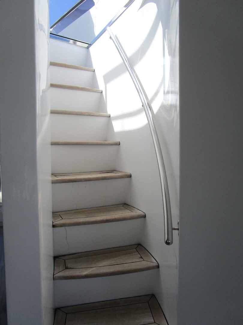 a white staircase with a glass door aboard DEAR HENRI Yacht for Sale