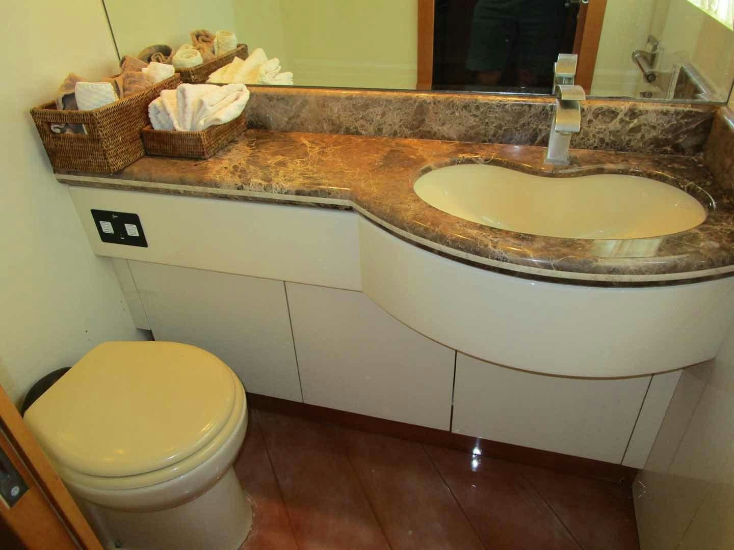 a bathroom with a sink and a toilet aboard DEAR HENRI Yacht for Sale