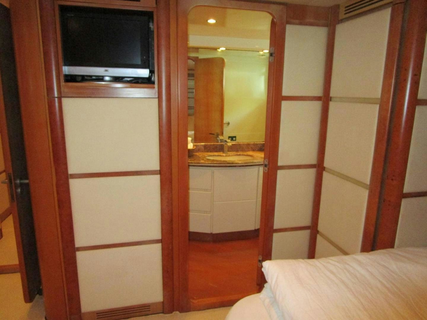 a bathroom with a bed and a television aboard DEAR HENRI Yacht for Sale