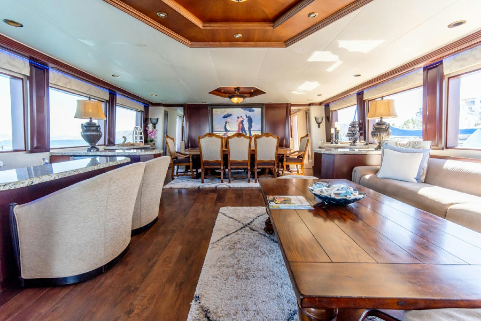 a living room with a wood table aboard NO EXCEPTIONS Yacht for Sale