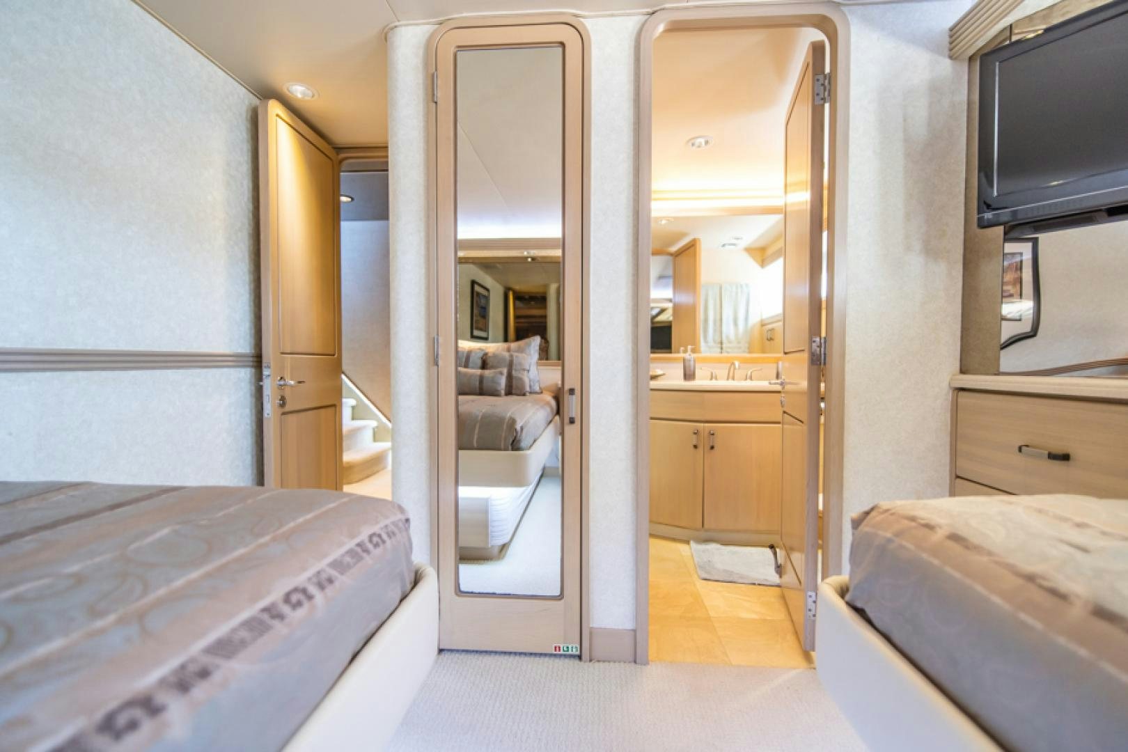 a room with a bed and a tv aboard NO EXCEPTIONS Yacht for Sale