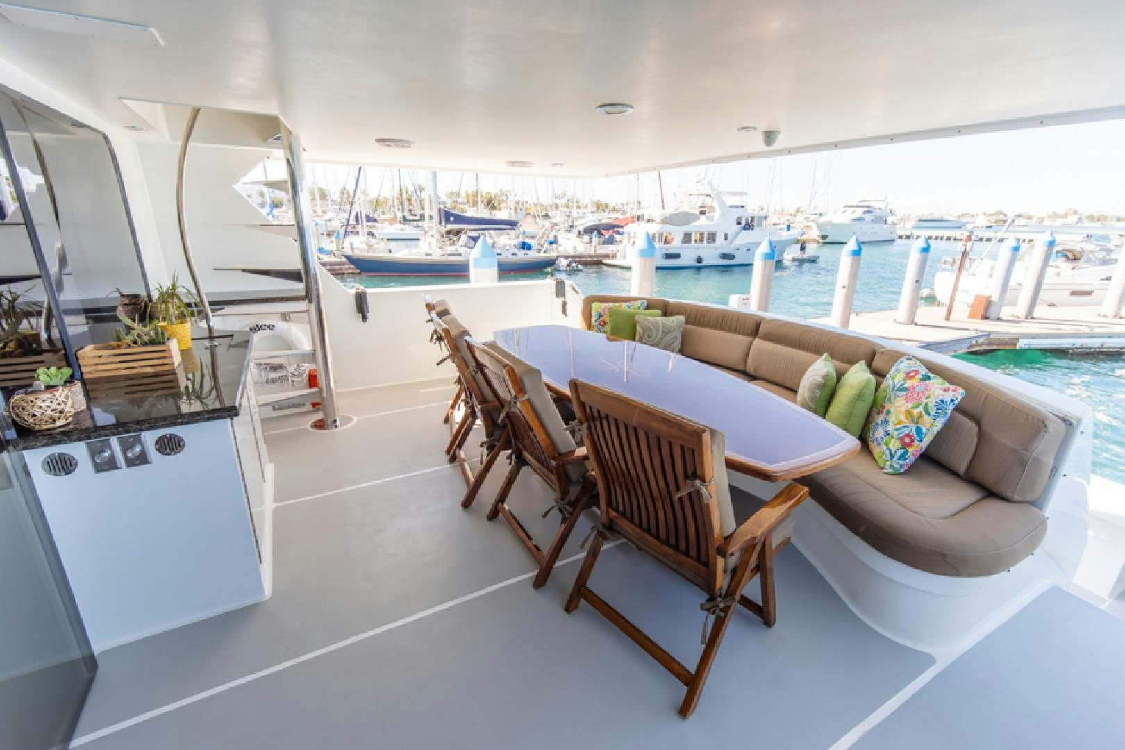a room with a table chairs and a view of the water aboard NO EXCEPTIONS Yacht for Sale