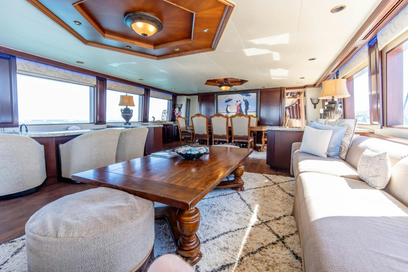 a living room with a table and couches aboard NO EXCEPTIONS Yacht for Sale
