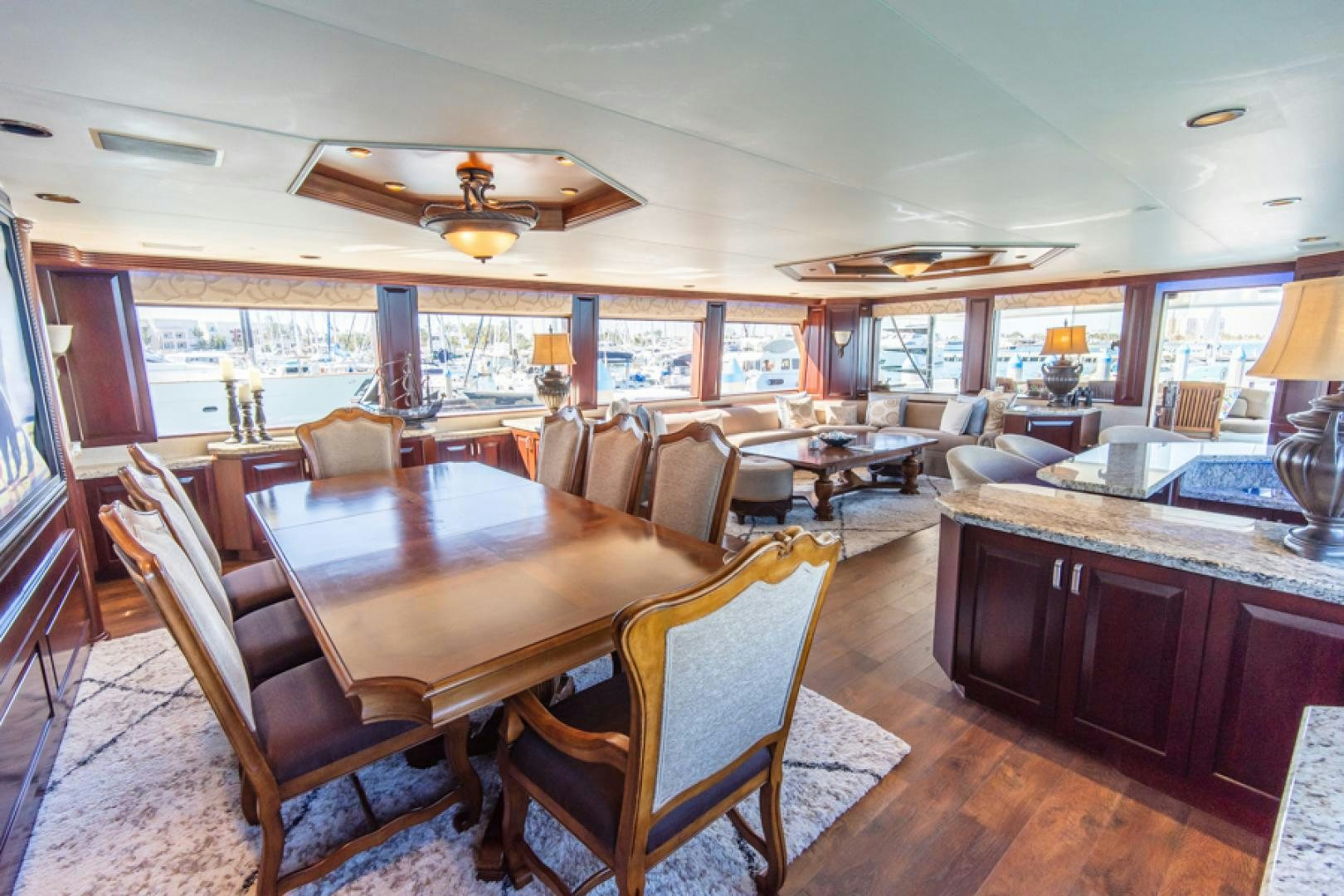 a large dining room with wood furniture aboard NO EXCEPTIONS Yacht for Sale