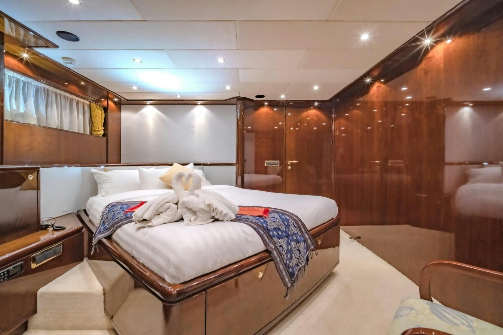 a room with a bed and a television aboard XANADU OF LONDON Yacht for Sale