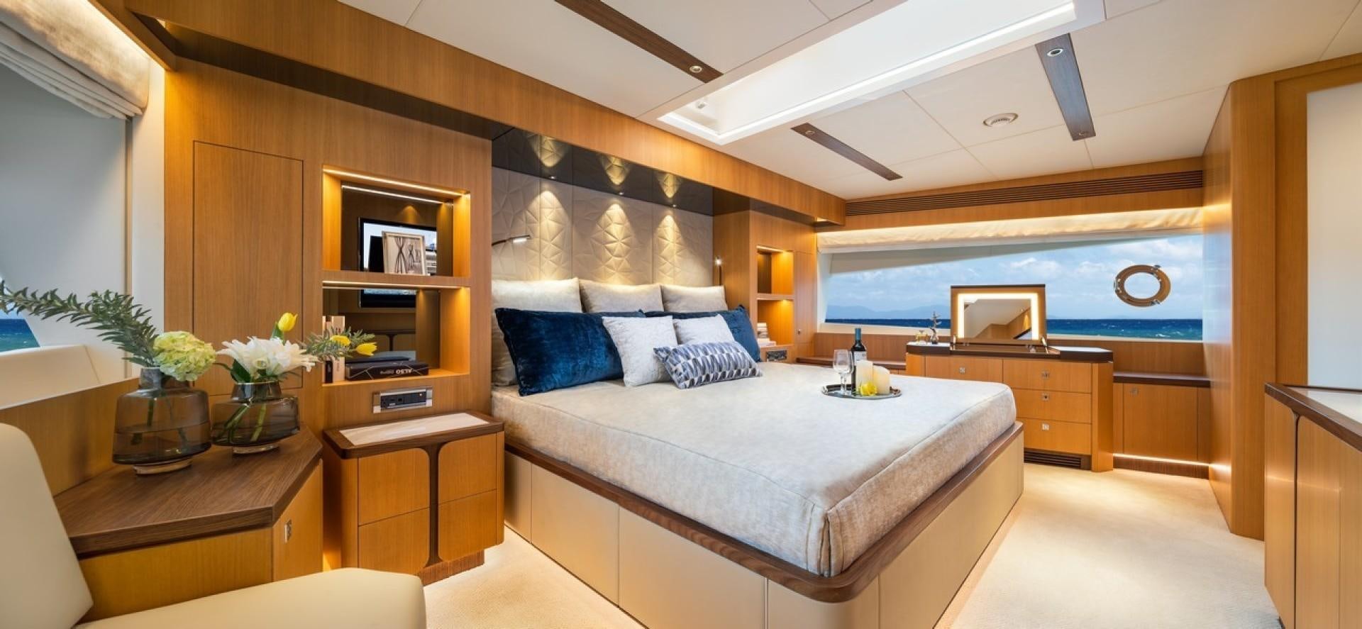 a large bedroom with a bed and desk aboard PARABOLIC Yacht for Sale