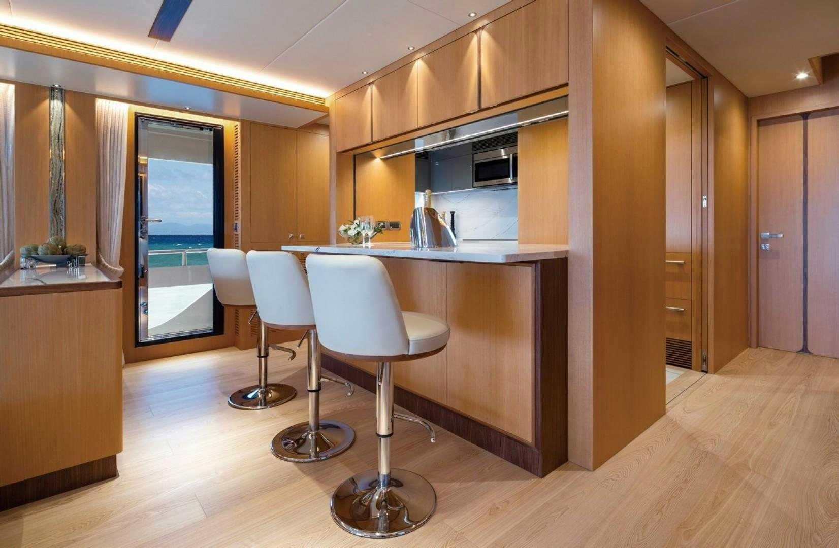 a kitchen with a table and chairs aboard PARABOLIC Yacht for Sale