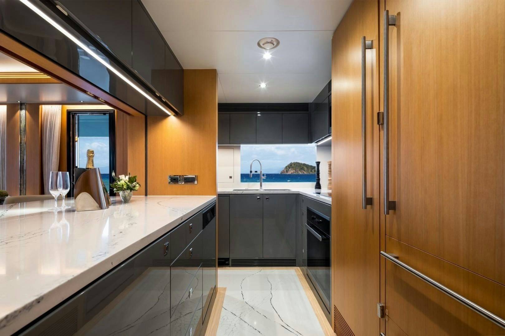 a kitchen with a large island aboard PARABOLIC Yacht for Sale