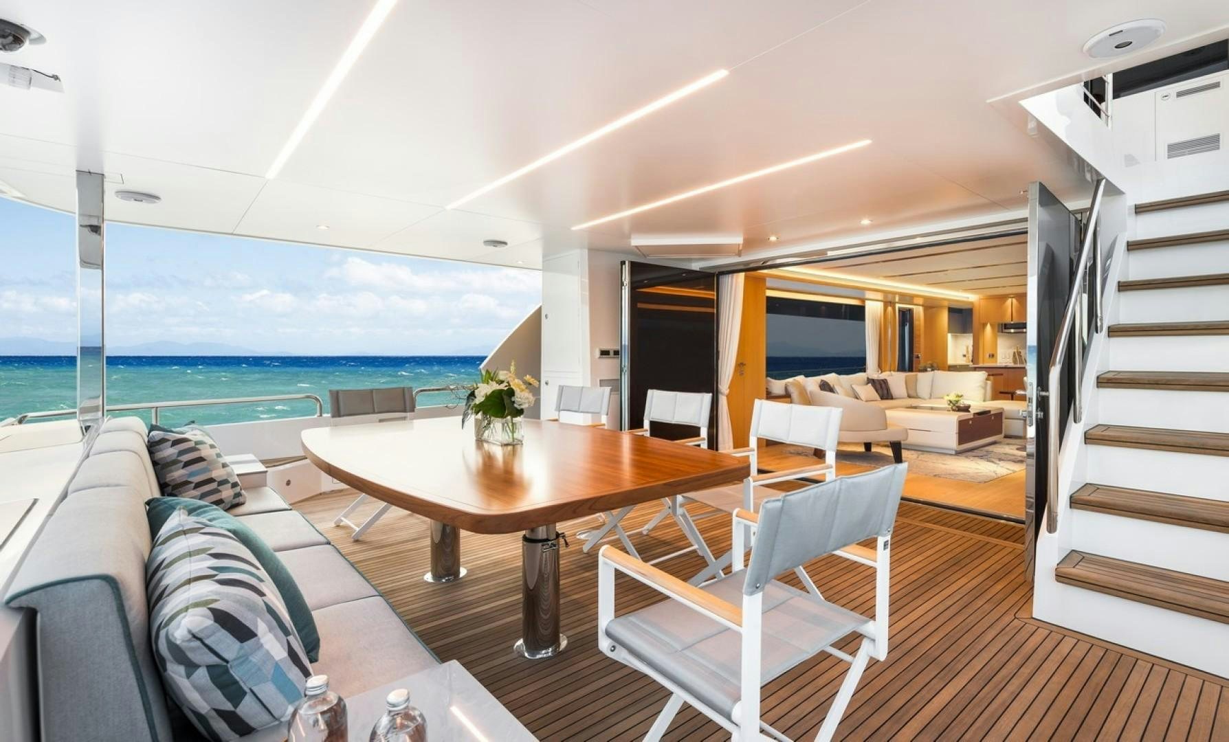 a living room with a table and chairs aboard PARABOLIC Yacht for Sale