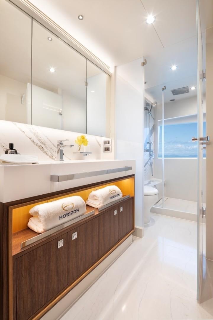 a bathroom with a large mirror aboard PARABOLIC Yacht for Sale