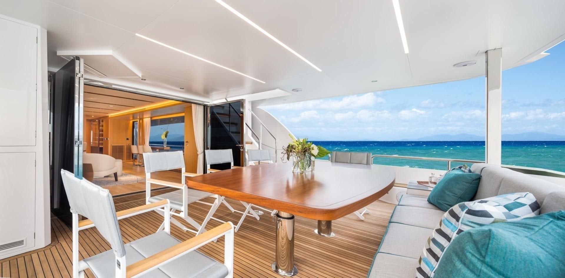 a room with a table chairs and a view of the ocean aboard PARABOLIC Yacht for Sale