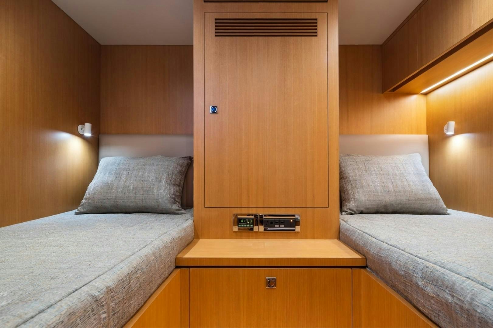 a room with a bed and a desk aboard PARABOLIC Yacht for Sale