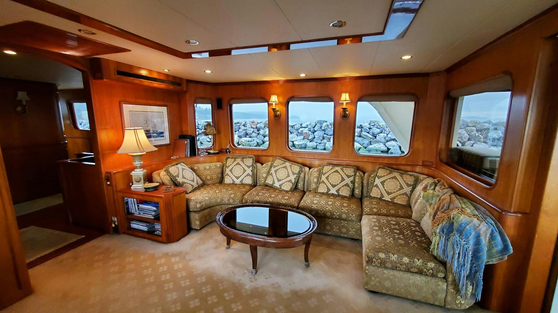 a living room with a couch and a coffee table aboard ANTARES Yacht for Sale
