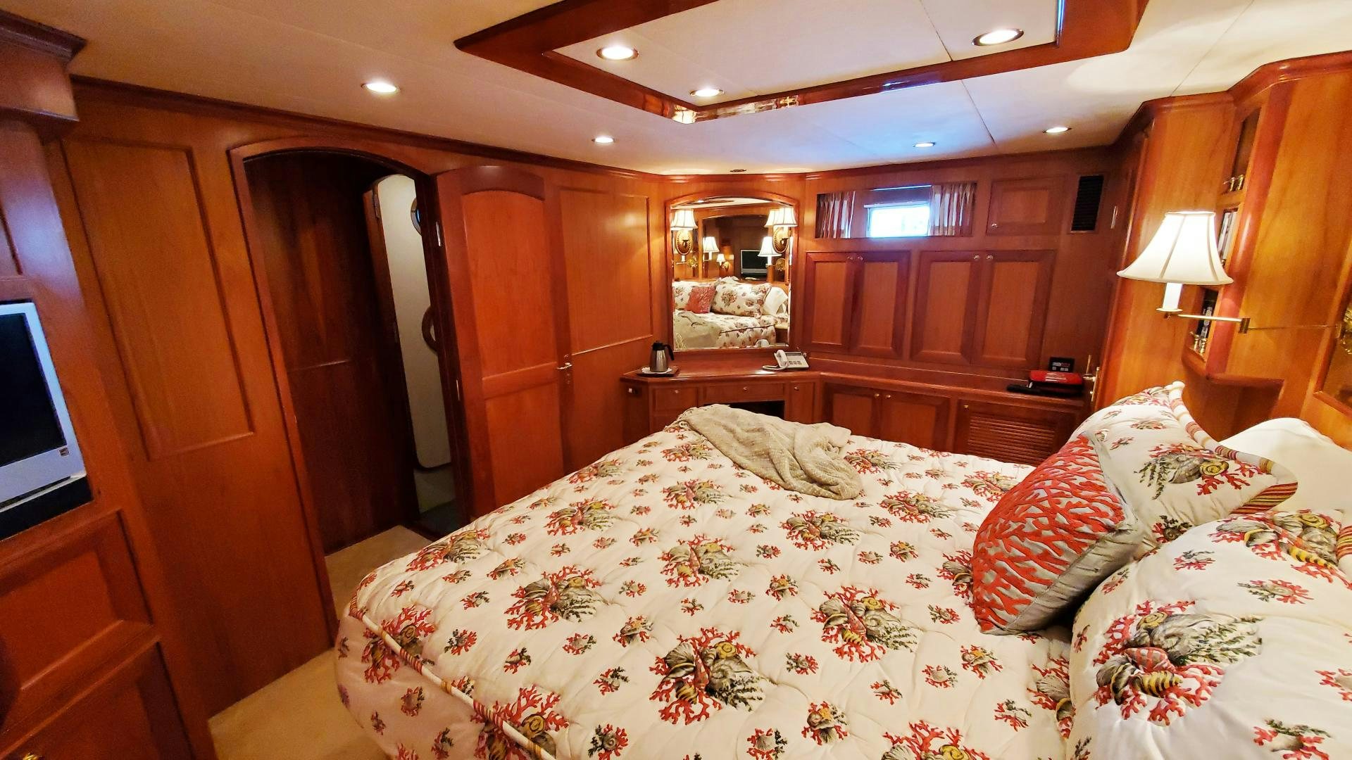 a bedroom with a bed and a television aboard ANTARES Yacht for Sale
