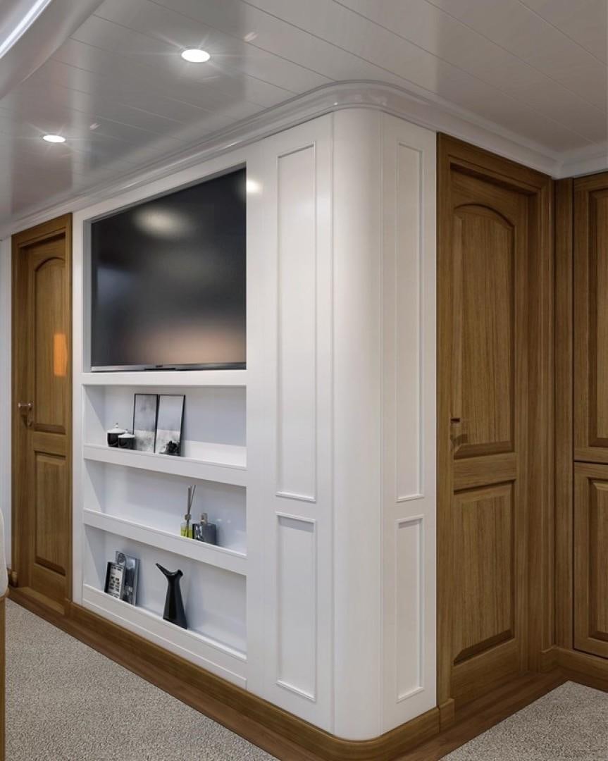 a white cabinet with a tv on it aboard ARK 401 Yacht for Sale