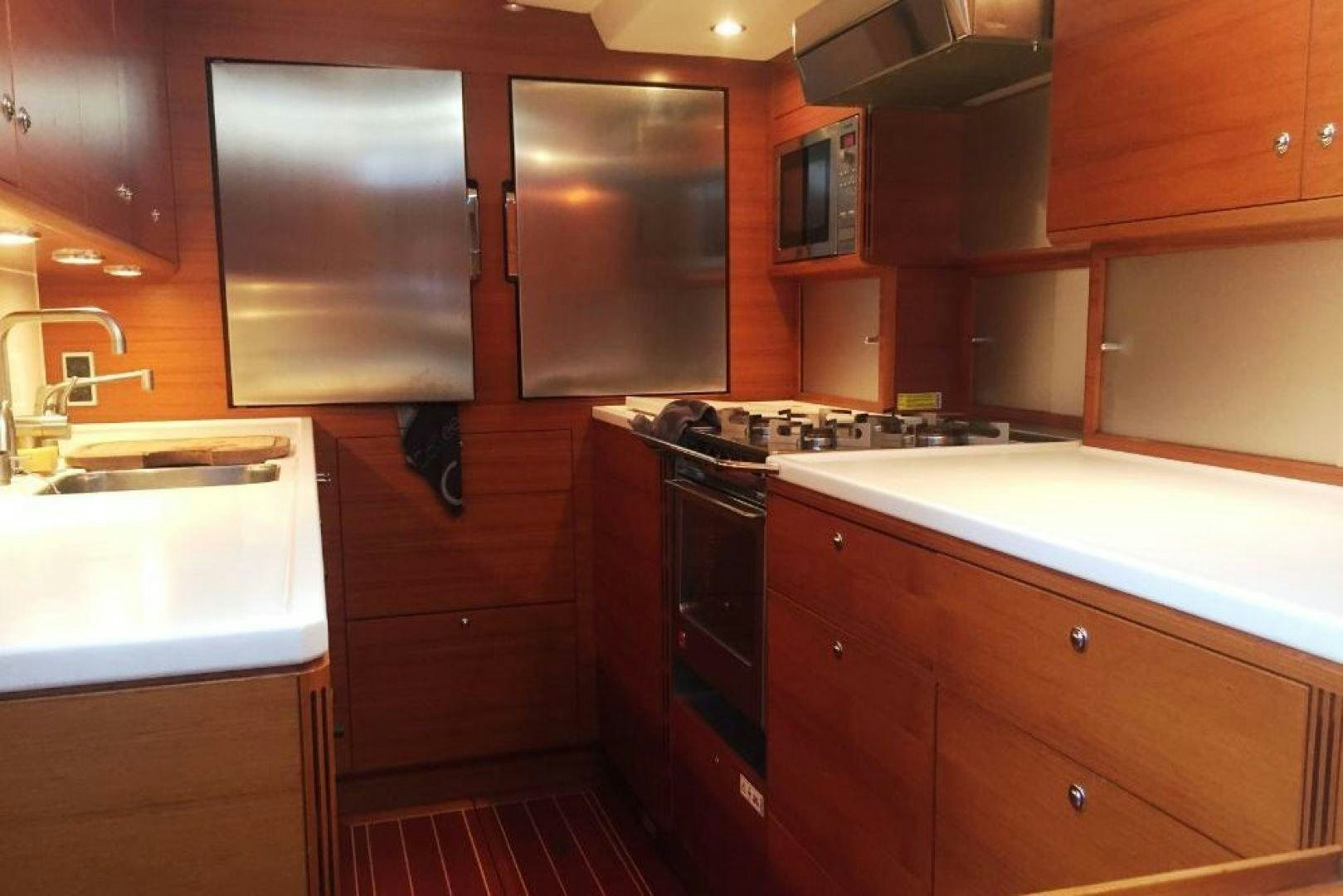 a kitchen with wooden cabinets aboard XERES Yacht for Sale