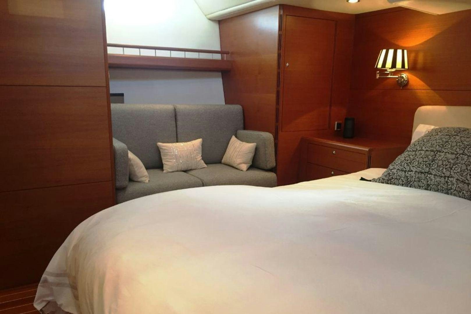 a bed with a white pillow aboard XERES Yacht for Sale