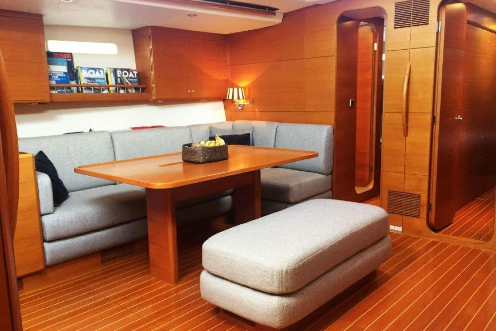 a room with a table and chairs aboard XERES Yacht for Sale