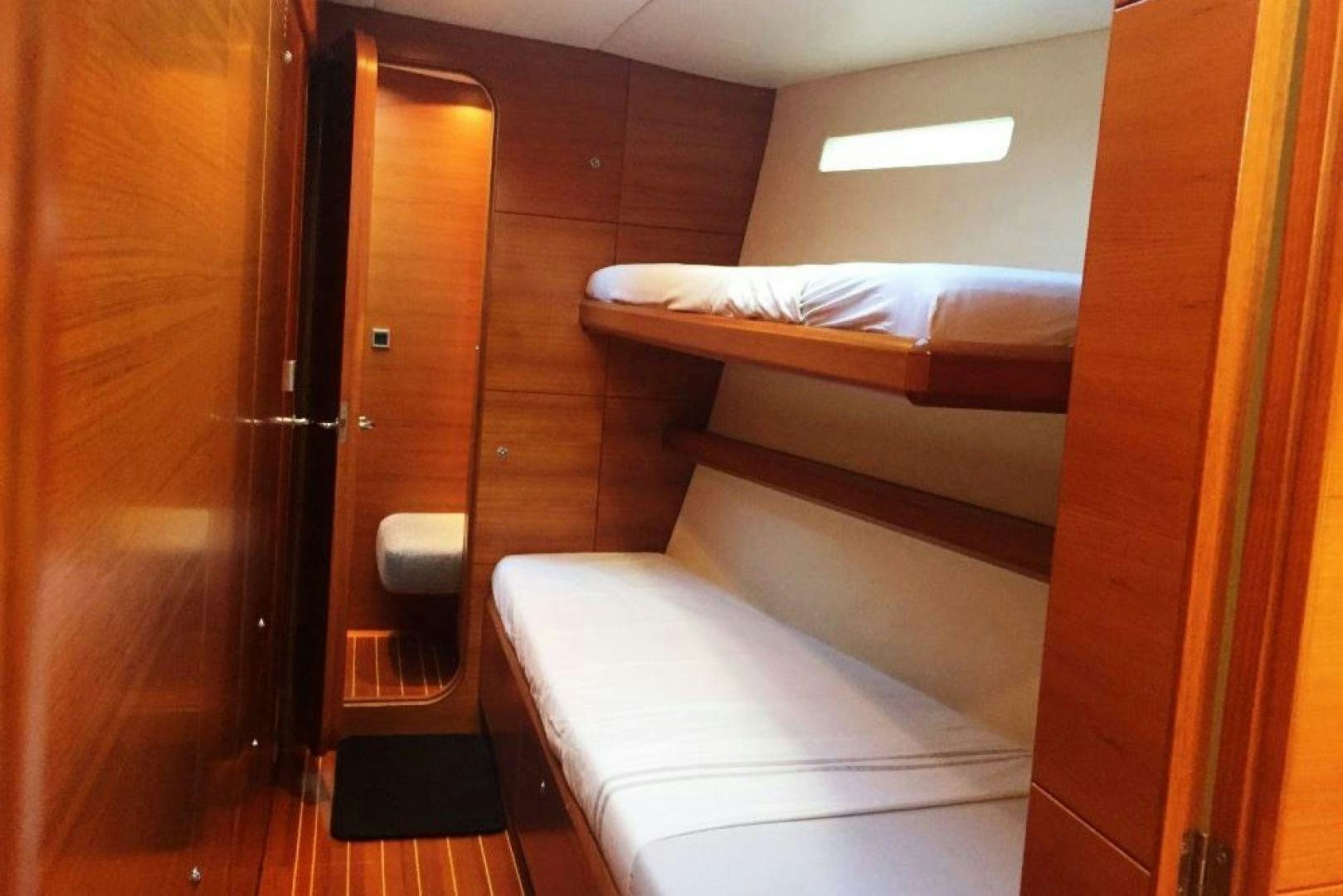 a room with a bed and a door aboard XERES Yacht for Sale