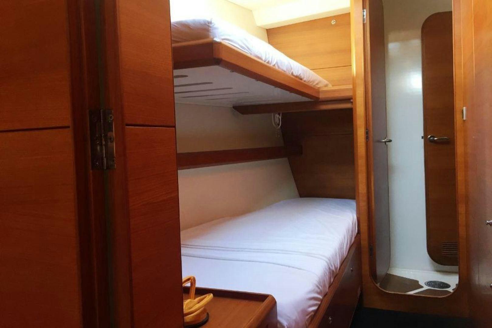 a room with a bed and a closet aboard XERES Yacht for Sale