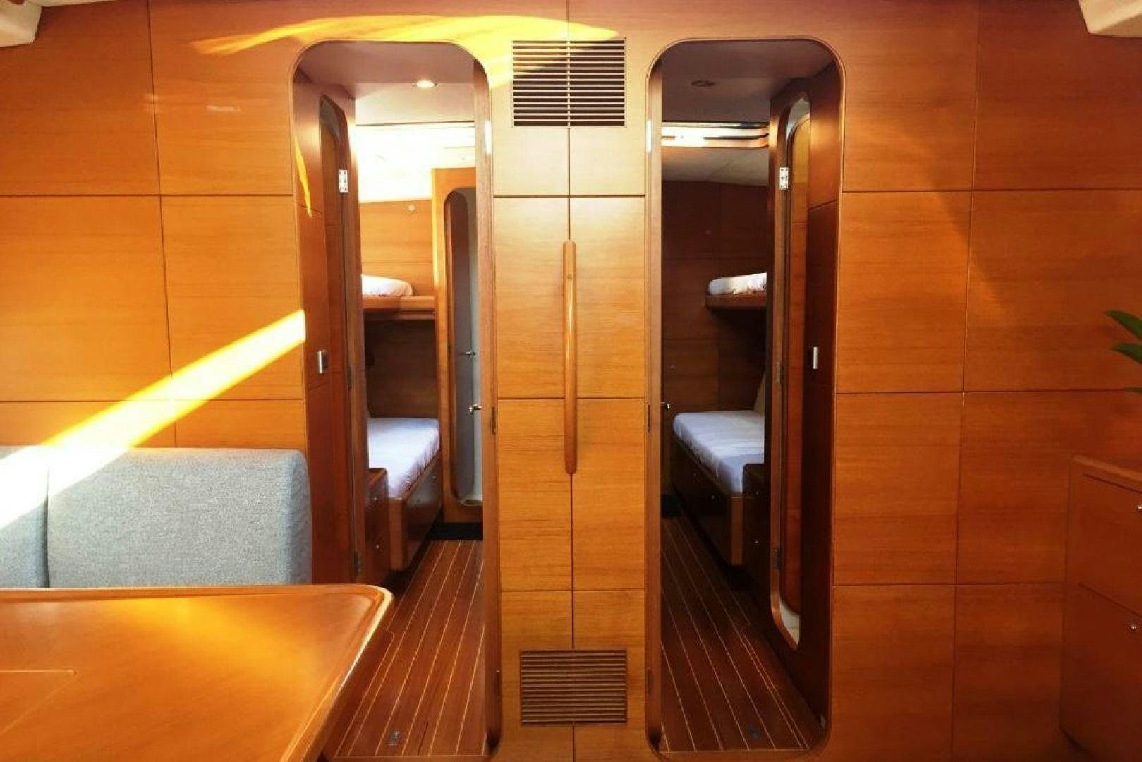 a room with a bed and a door aboard XERES Yacht for Sale