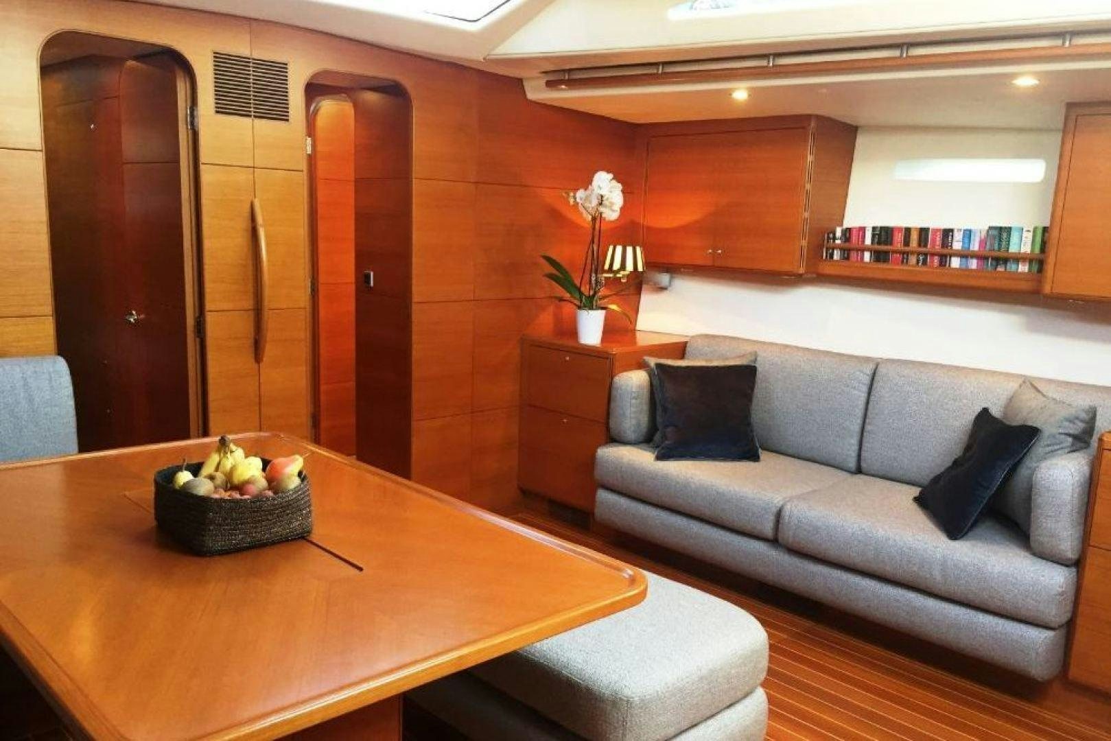 a couch and a table in a room aboard XERES Yacht for Sale