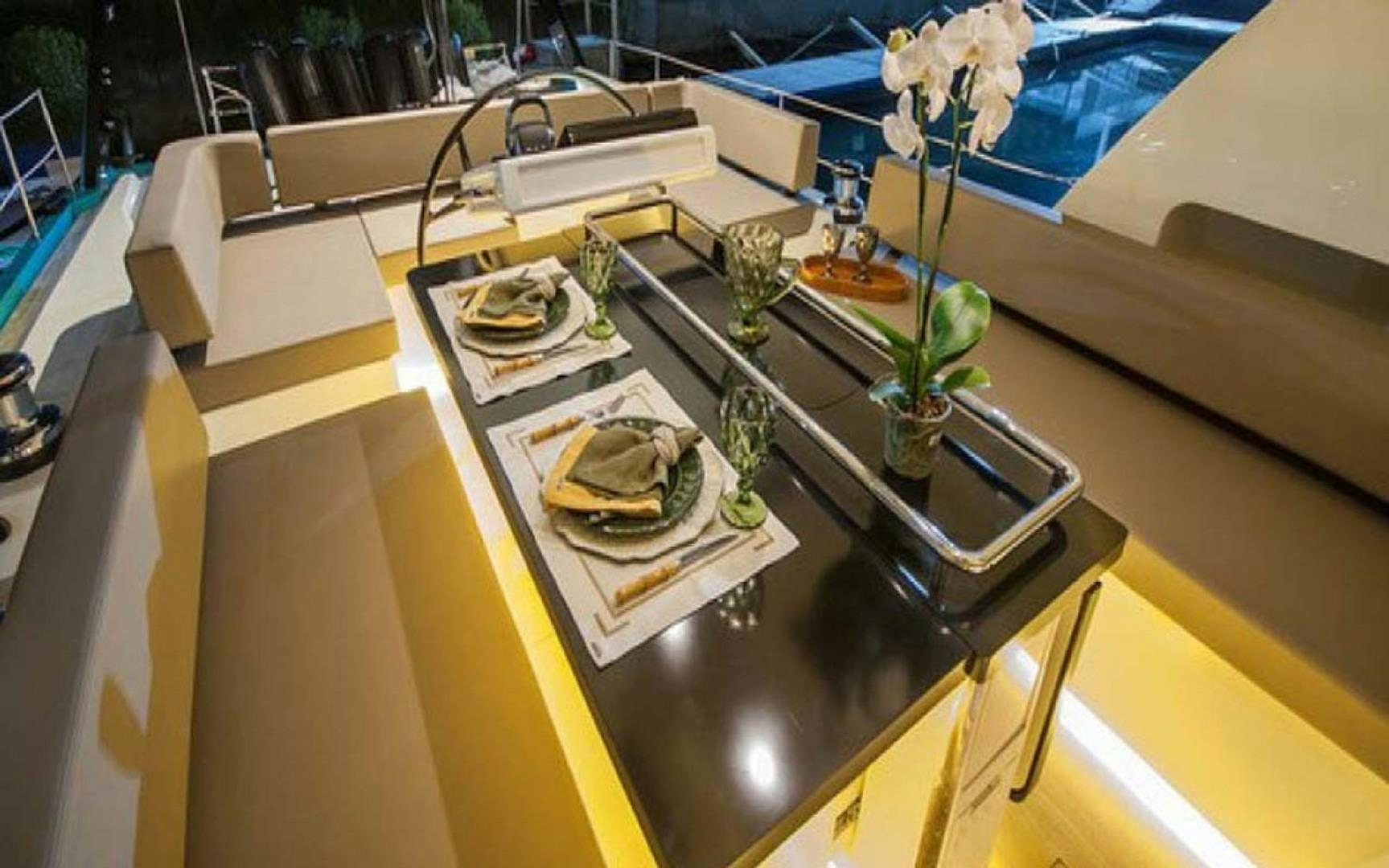 a table with a few plates and cups on it aboard LAS BRISAS Yacht for Sale