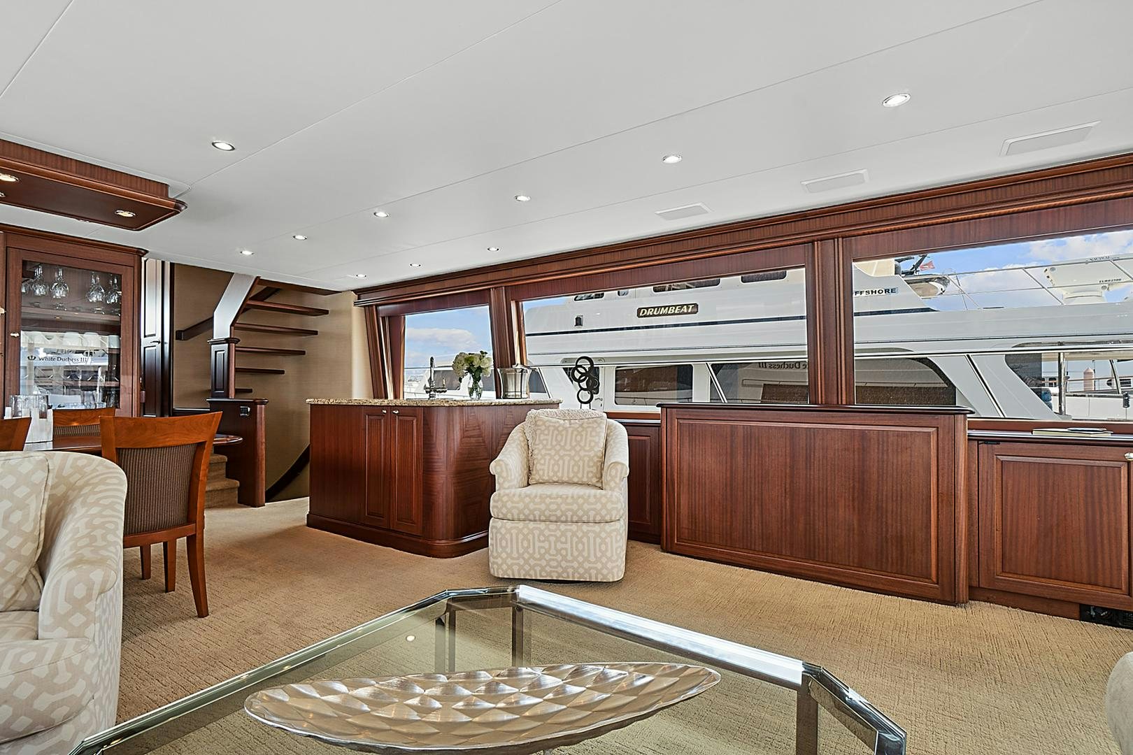 a living room with a table and chairs aboard LADY B Yacht for Sale
