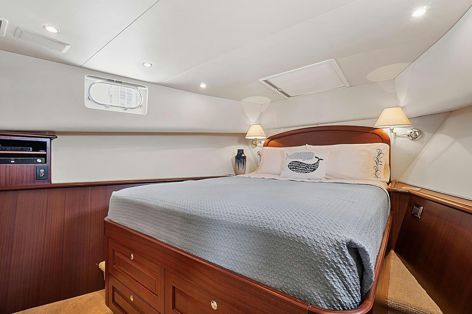 a bed with a wooden headboard aboard LADY B Yacht for Sale