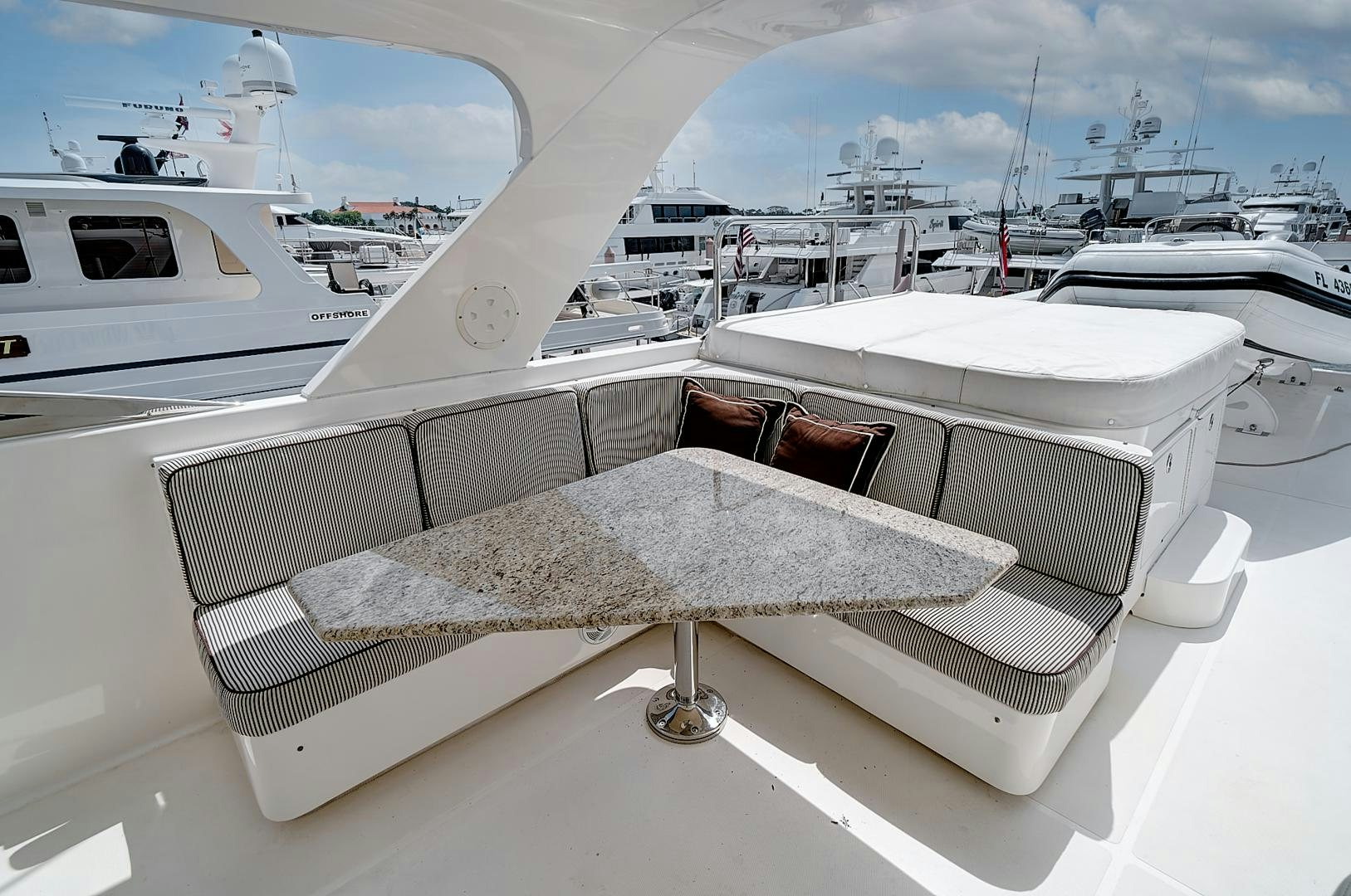 a white boat with a white cover aboard LADY B Yacht for Sale