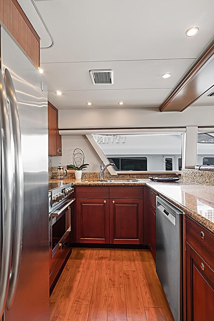a kitchen with a stainless steel refrigerator aboard LADY B Yacht for Sale