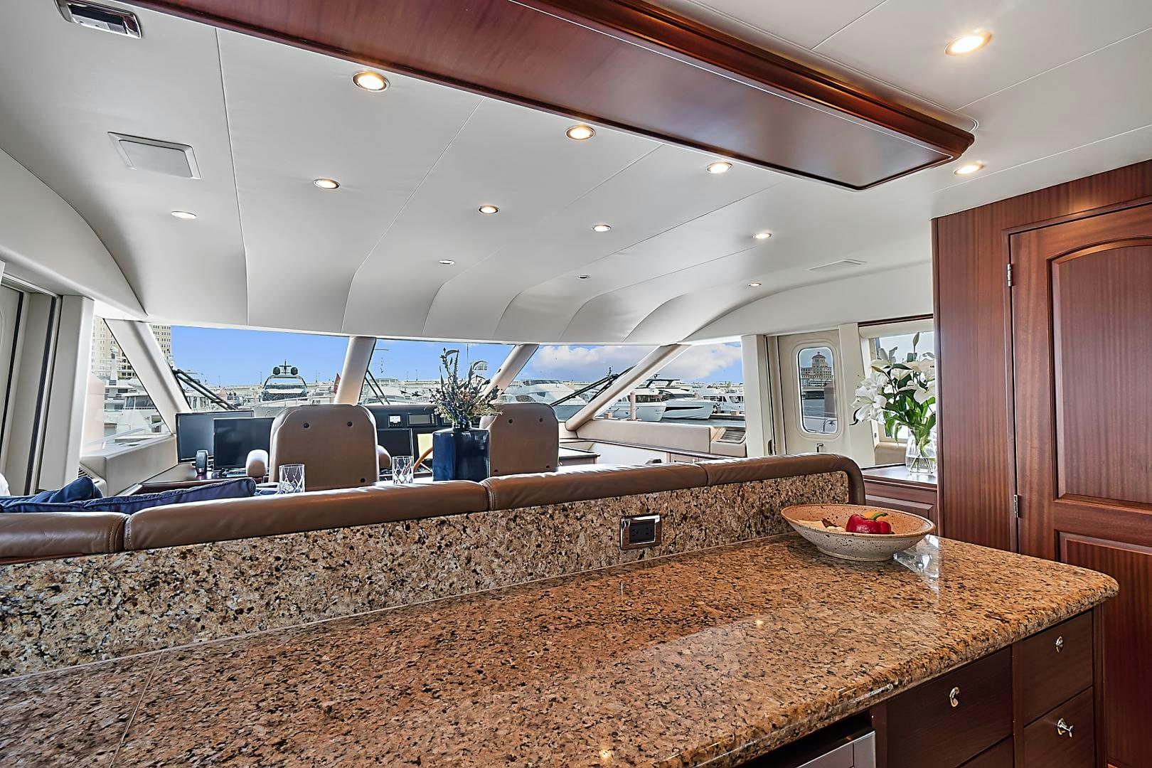 a kitchen with a large marble counter top and a large window aboard LADY B Yacht for Sale