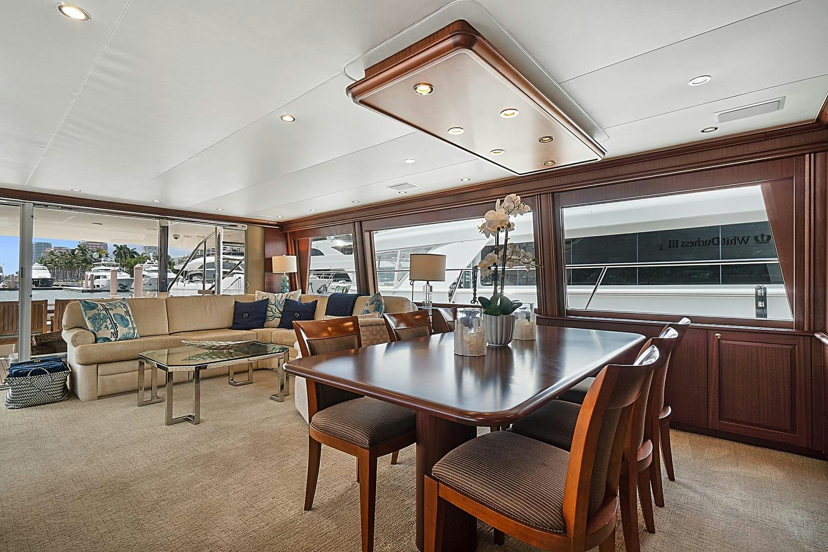 a large living room with a table and chairs aboard LADY B Yacht for Sale
