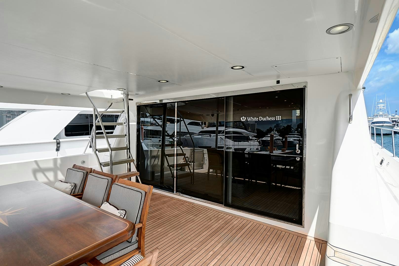 a room with a table chairs and a large window aboard LADY B Yacht for Sale