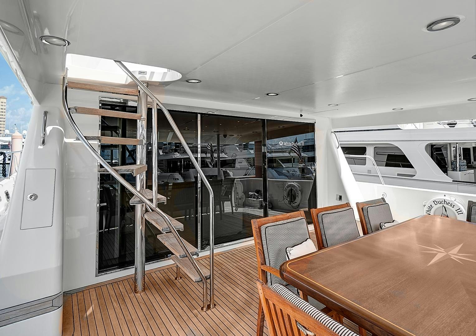 a room with a table and chairs aboard LADY B Yacht for Sale