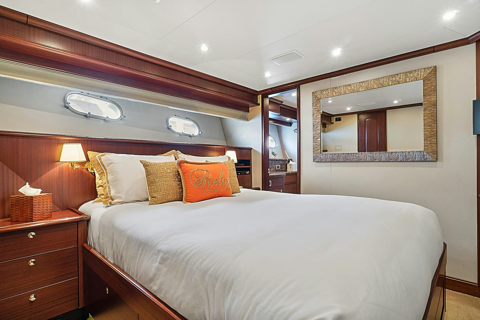 a bed with a mirror above it aboard LADY B Yacht for Sale