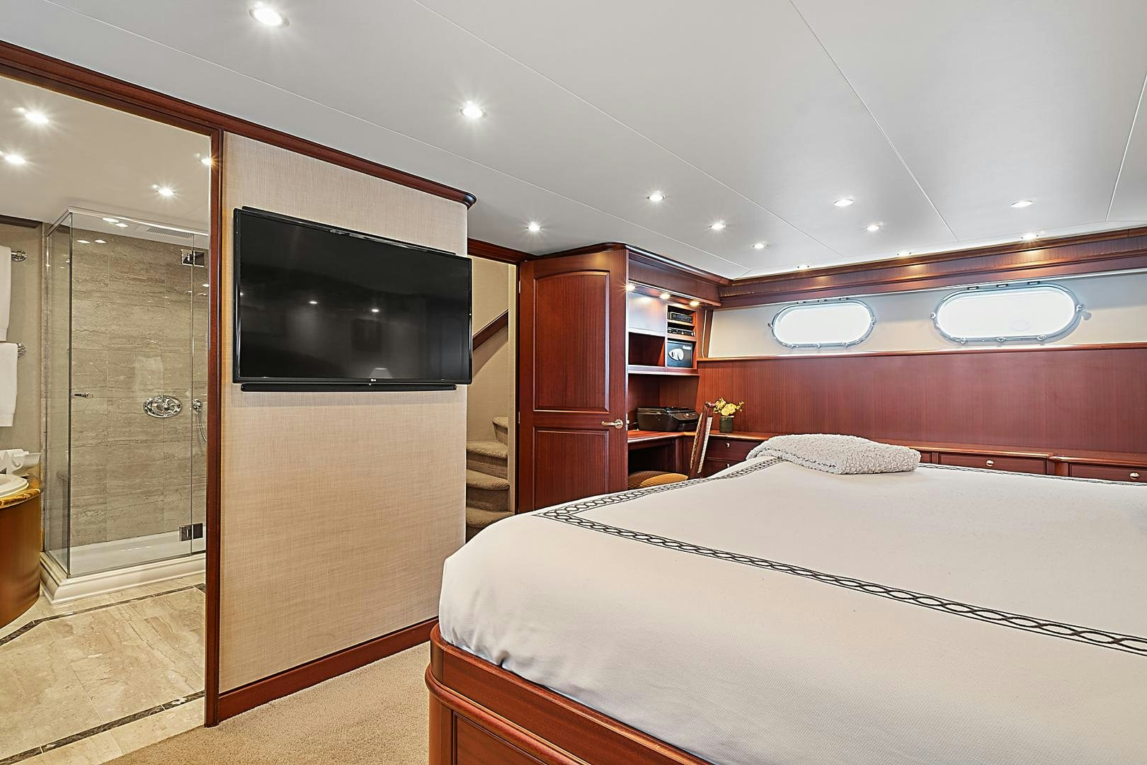 a bedroom with a bed and a tv aboard LADY B Yacht for Sale