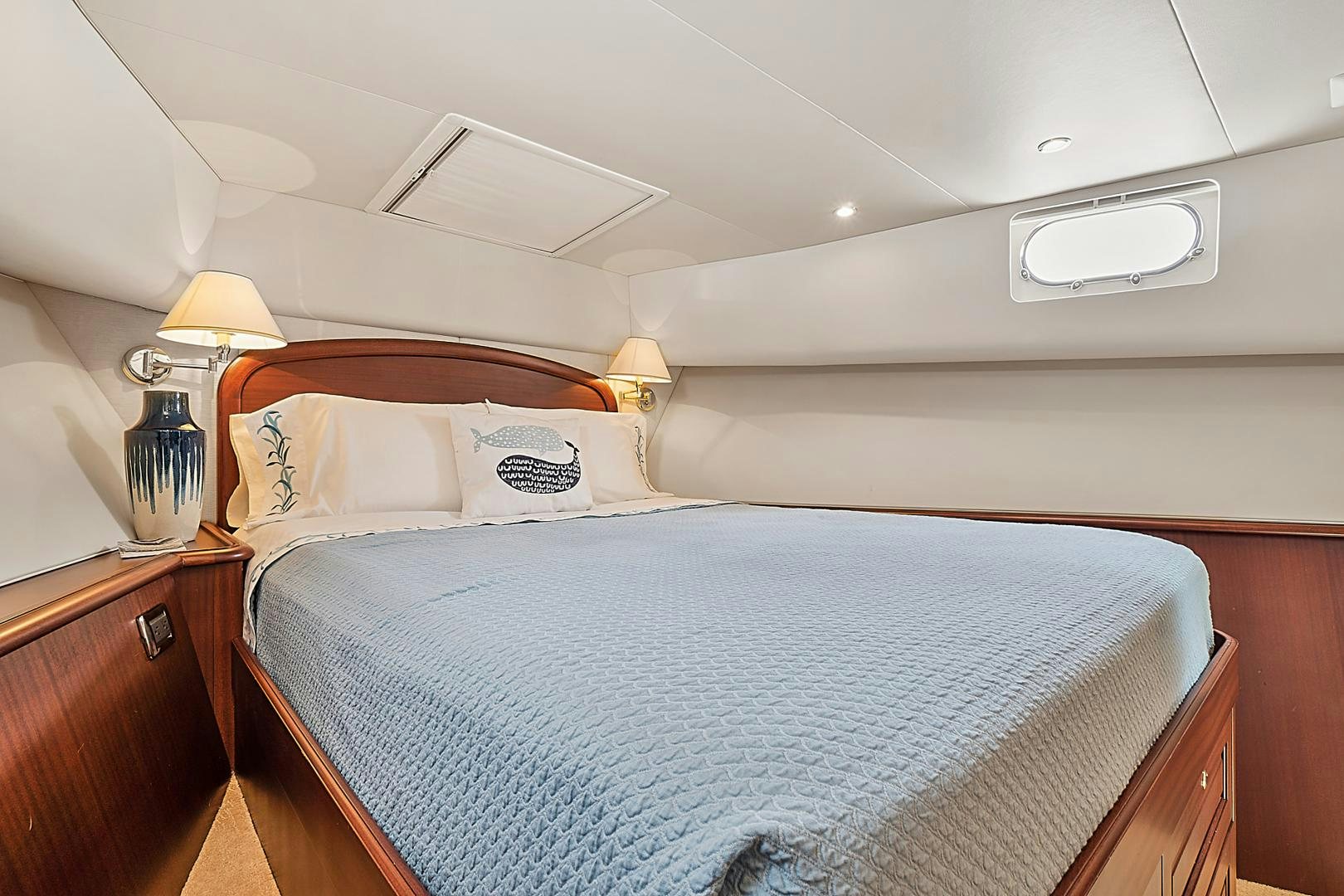 a bed with a blue comforter aboard LADY B Yacht for Sale