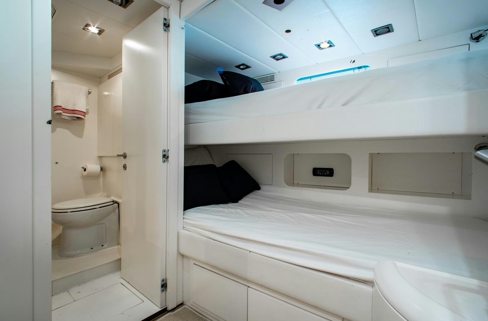 a bathroom with a bed and a toilet aboard SMILE Yacht for Sale