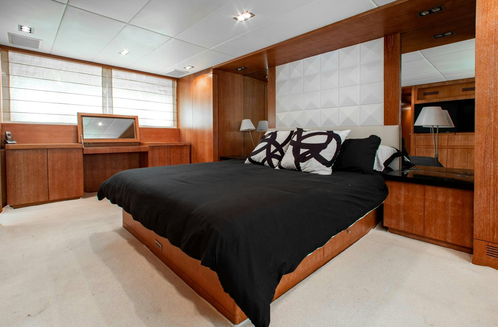 a bedroom with a large bed aboard SMILE Yacht for Charter