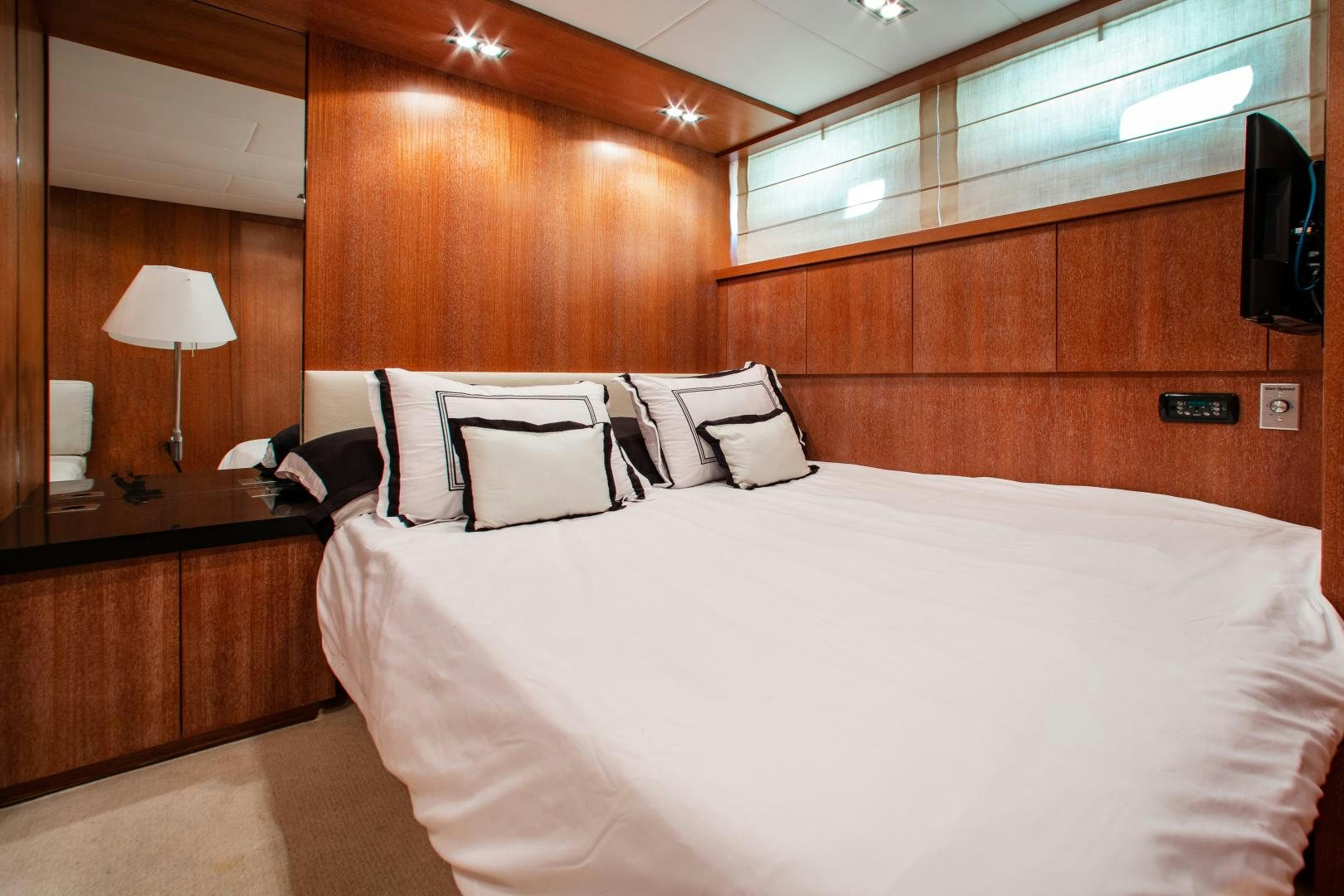 a bed with white sheets aboard SMILE Yacht for Sale