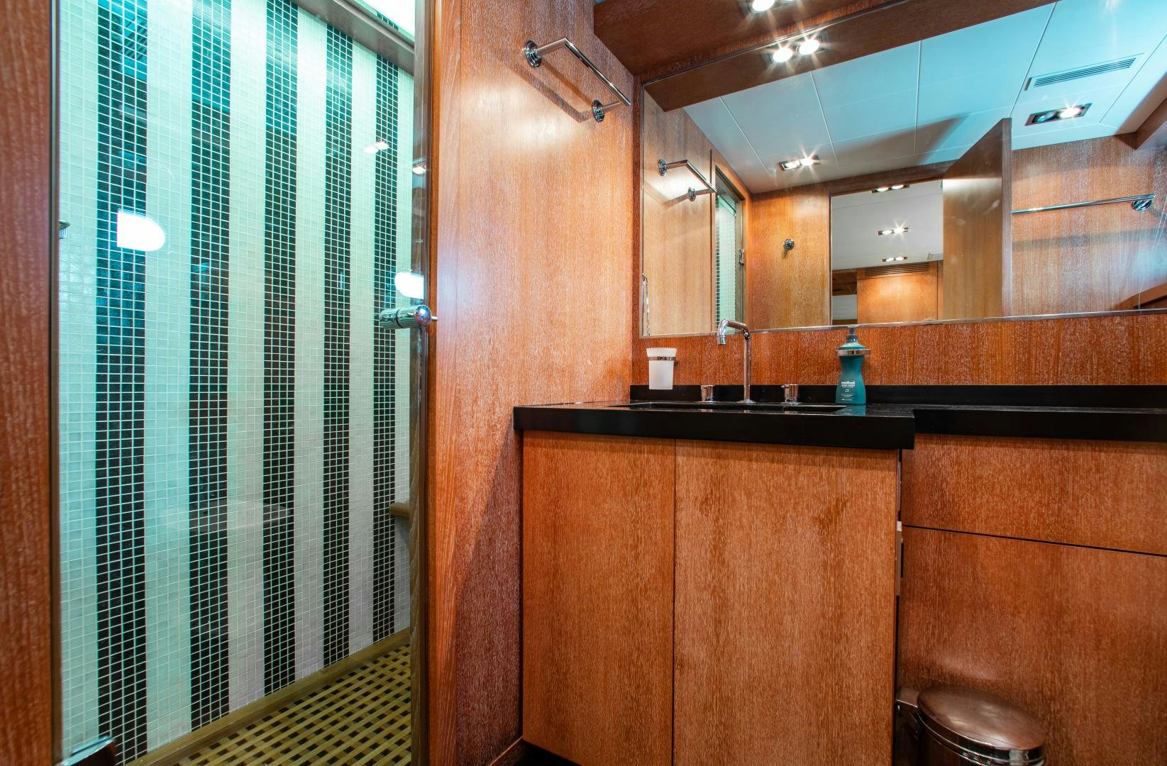 a bathroom with wooden cabinets aboard SMILE Yacht for Sale