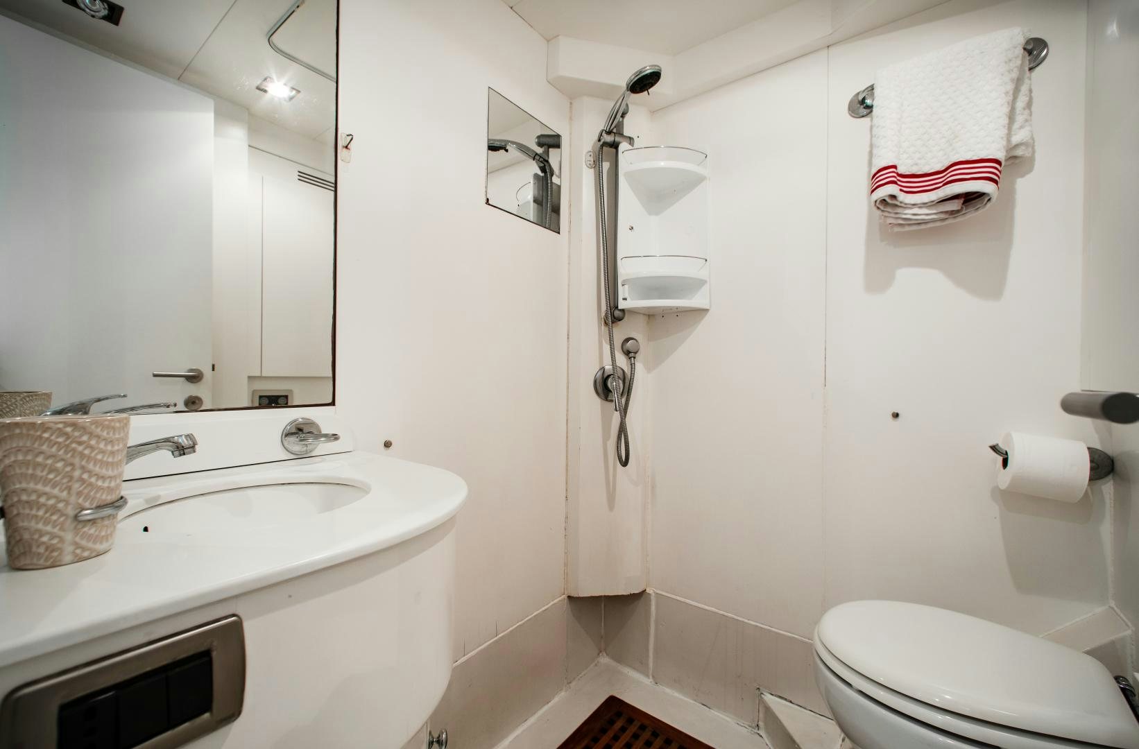 a bathroom with a sink toilet and towels aboard SMILE Yacht for Sale