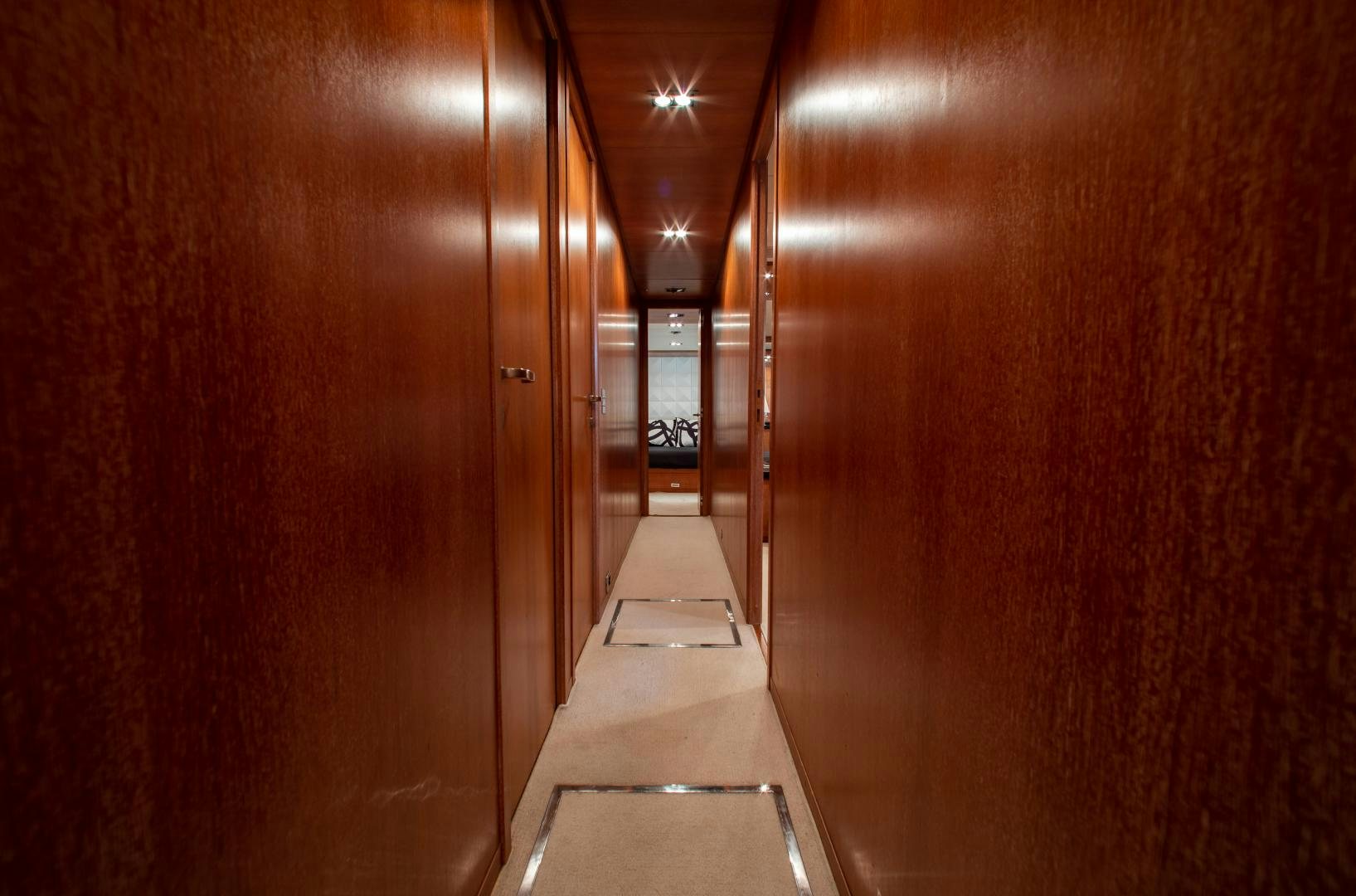 a long hallway with a white staircase aboard SMILE Yacht for Sale