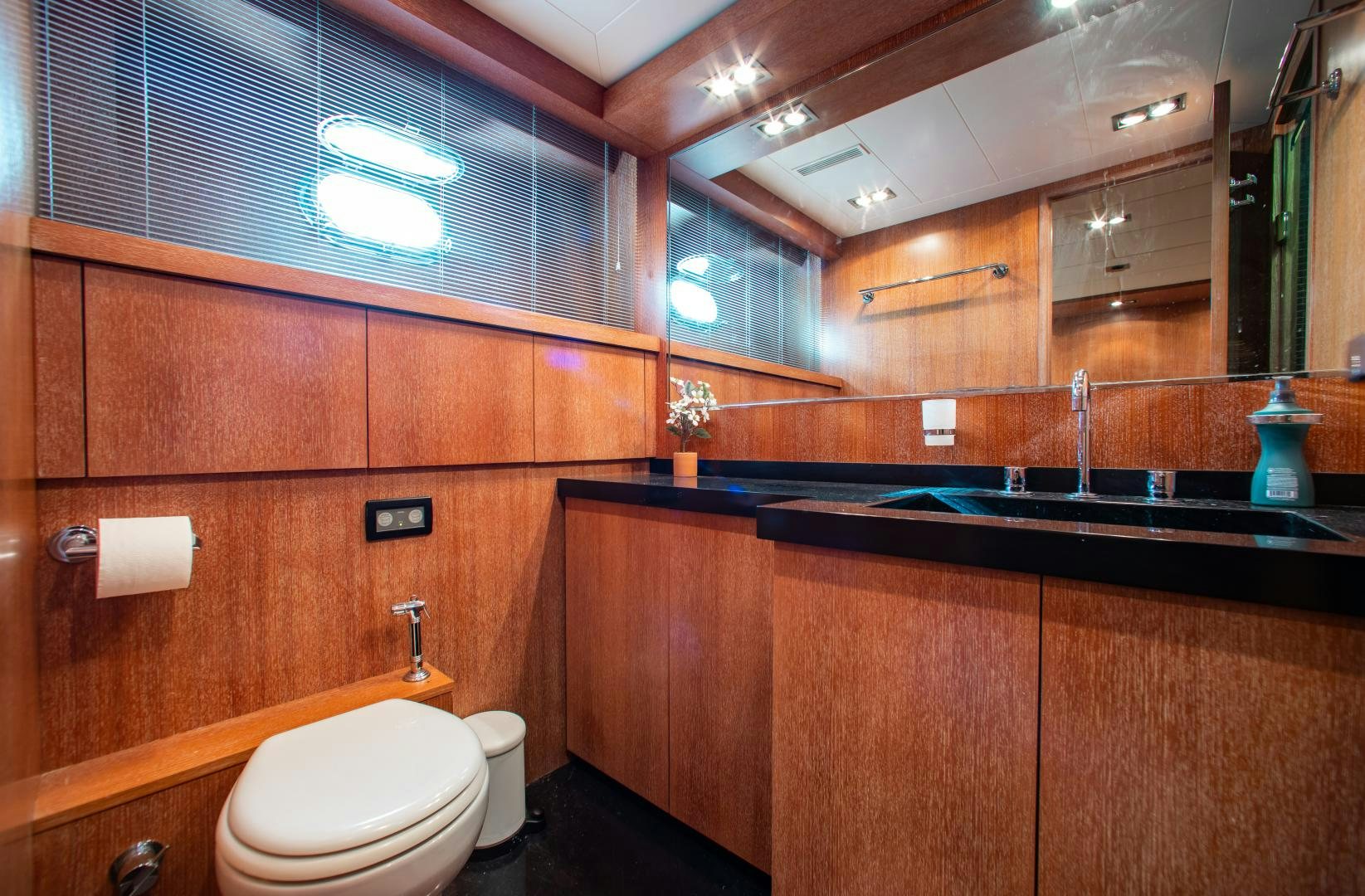 a bathroom with wooden cabinets aboard SMILE Yacht for Charter