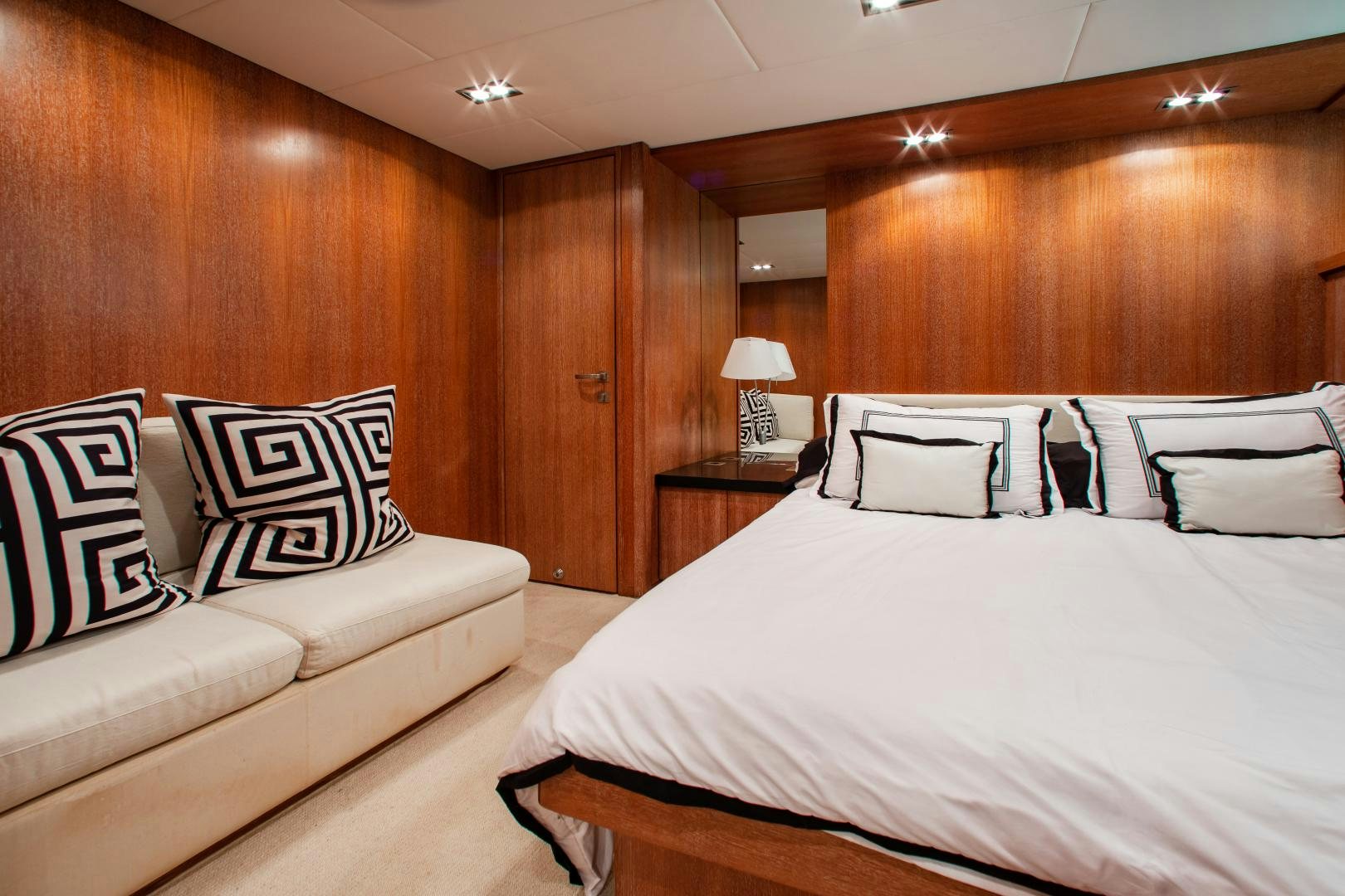 a room with a bed and a couch aboard SMILE Yacht for Sale