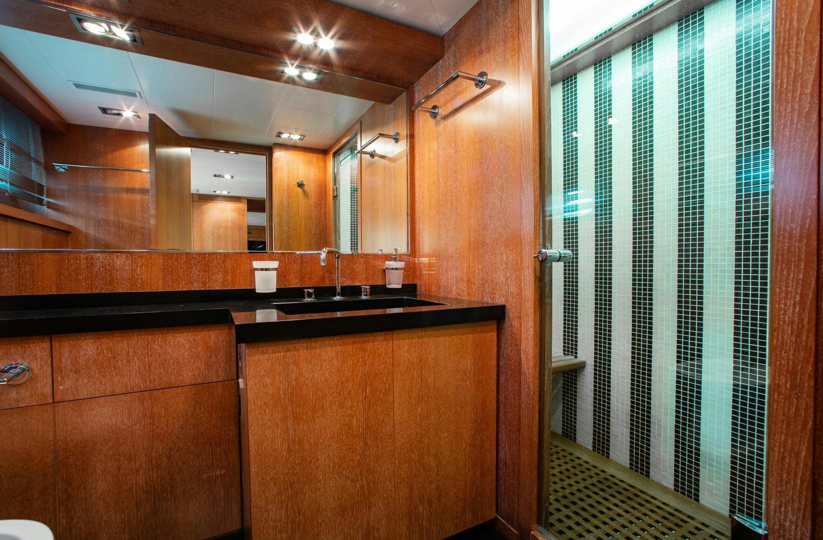 a bathroom with a sink and cabinets aboard SMILE Yacht for Sale
